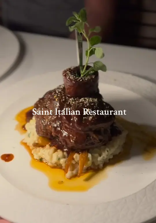 Saint in St. Augustine showing review, patio table, sunset, wood-grilled fillet, vitruvian drink, video by hellostaugustine on TikTok