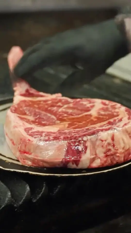 Saltwater Grill in Panama City Beach showing food, tomahawk steak, pork chop, video by Saltwater Grill on Facebook