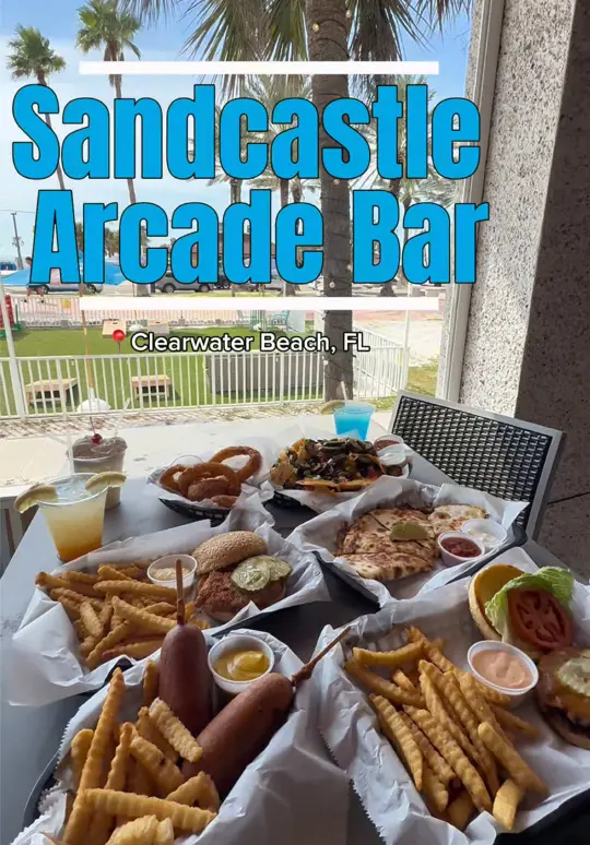 Sandcastle Arcade Bar & Grill in Clearwater Beach showing food, level-up nachos, boss battle dilla, cluck 'n load, burger time, cocktails, video by eatlocalflorida on TikTok