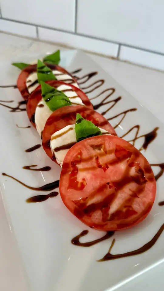 Santa Fe Cafe in Naples showing food, caprese salad, video by Santa Fe Naples on Facebook