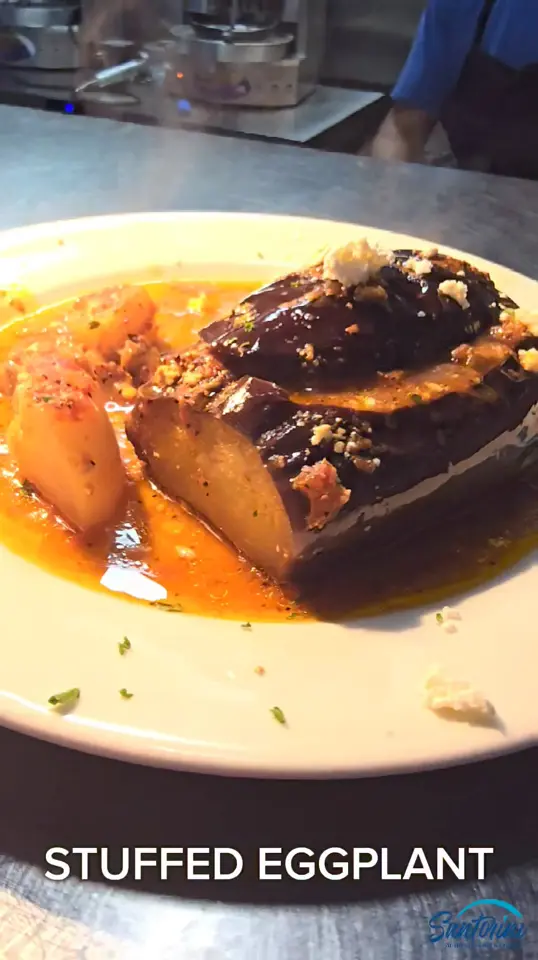 Santorini Greek Restaurant in Johns Creek showing food, stuffed eggplant, video by Santorini Greek Restaurant on Facebook