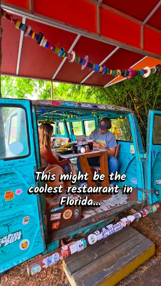 Satchel's Pizza in Gainesville showing pizza, vintage volkswagen van interior, airplane seating, plants for sale, upcycled art, homemade sodas, video by The Florida Tribe on Facebook