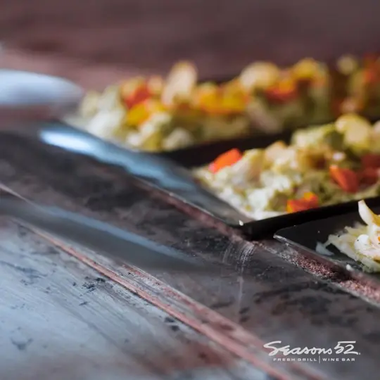 Seasons 52 in Buford showing seasonal menus, wines by the glass, video by Seasons 52 on Facebook