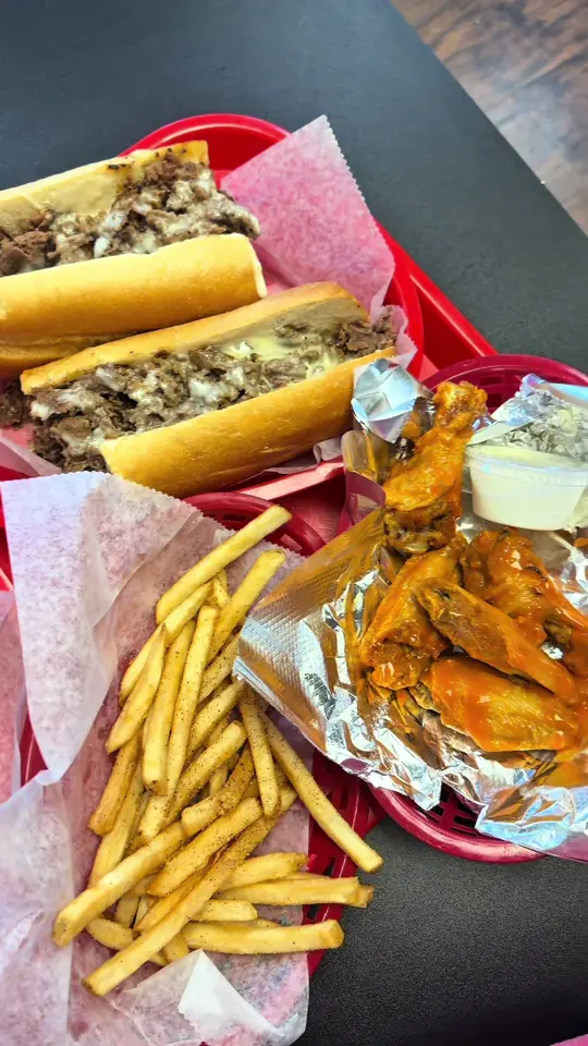 South Philly Steaks in Orlando showing review, cheesesteak, buffalo wings, cajun fries, video by heatherhasplans on TikTok