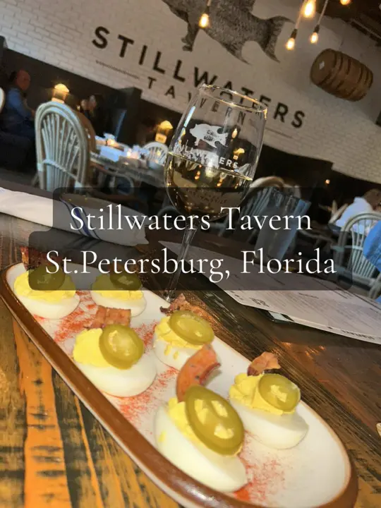 Stillwaters Tavern in St. Petersburg showing dinner, fried green tomatoes, crab hushpuppies, deviled eggs, fish and chips, meatloaf, vegan thai salad, video by tastemichigan on TikTok