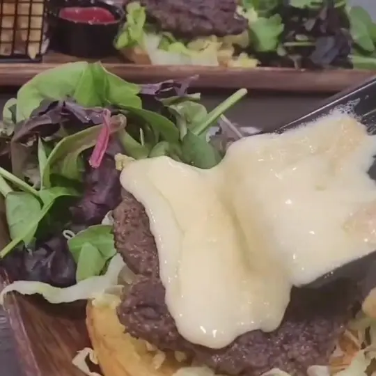 T.I.G.F (this is garden food) in Port St. Joe showing burger, raclette swiss cheese, video by TIGF " This is garden food " on Facebook