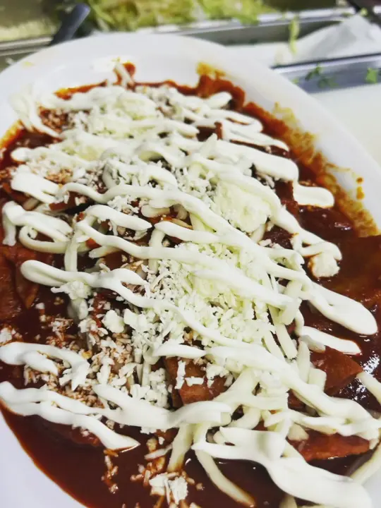 Taqueria Herencia Mexicana in Hialeah showing chilaquiles rojos, chilaquiles verdes, video by Taqueria Herencia Mexicana on Facebook