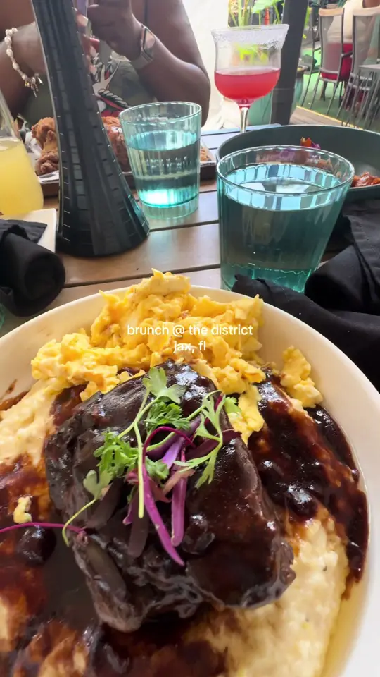 The District SPR in Jacksonville showing brunch, short rib & grits, video by breeski2x on TikTok