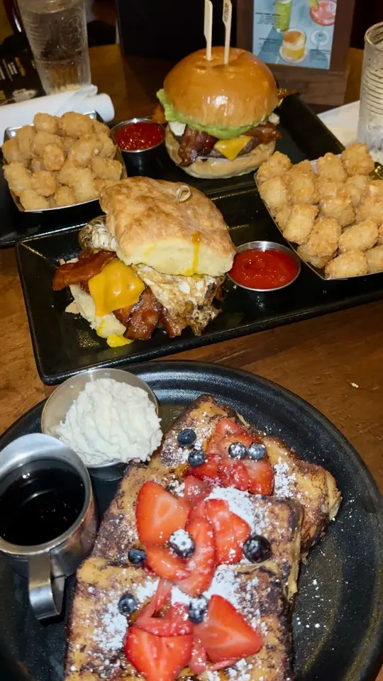 The Edison in Lake Buena Vista showing brunch, bloody mary, piggyback maple old-fashioned, classic deviled eggs, sticky money break, the brunch stack burger, video by Brian Treks on Facebook