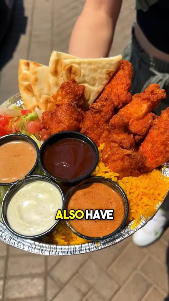 The Halal Guys in Duluth showing food, crunchy chicken wings, sauces, video by Foodbeast on Facebook