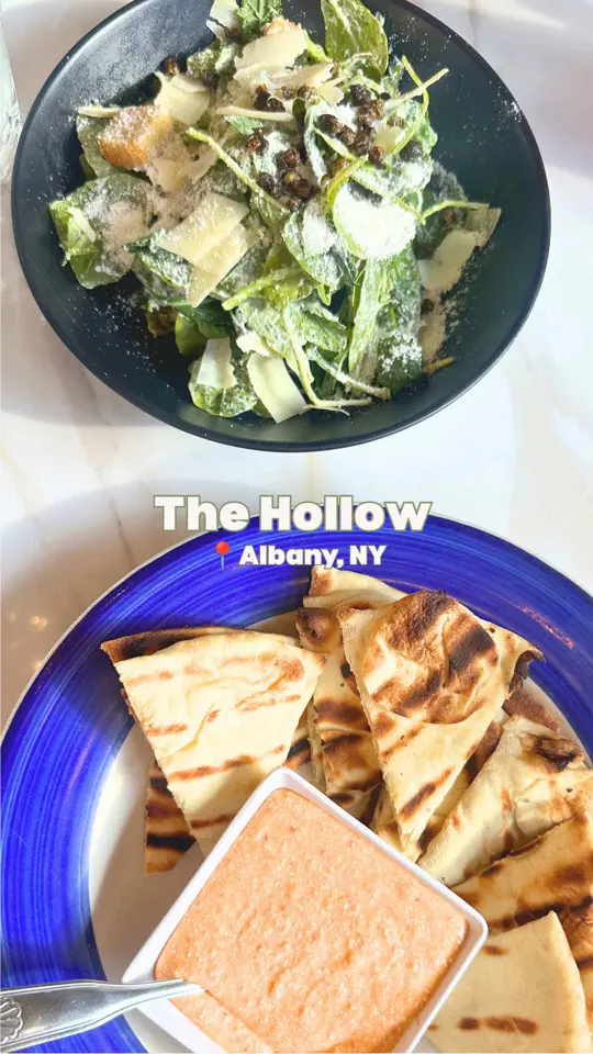 The Hollow Bar + Kitchen in Albany showing food, spicy feta dip with grilled naan / food, kale caesar / food, tennessee hot grilled chicken sandwich / food, riggies / food, rotating bread pudding / live, video by michellahand on TikTok