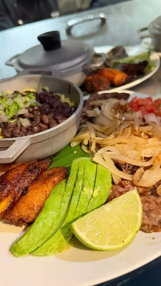 The Hush Cuban Kitchen in Clarkesville showing food, grilled steak with caramelized onions / food, sweet plantains & black beans / food, fresh avocado and house-made sauces, video by The Hush Cuban Kitchen on Facebook