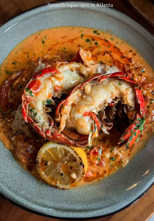The Iberian Pig in Decatur showing visit, review, tapas, caviar con papas, gambas al ajillo, patatas bravas, langosta, paella, cocktails, aqua de la tierra, video by eatclickrepeat on TikTok