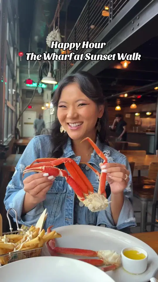 The Wharf at Sunset Walk in Kissimmee showing happy hour, crab legs, truffle fries, fresh ahi tuna stack, fish & chips, sesame ginger seabass, video by taylorshennett on TikTok