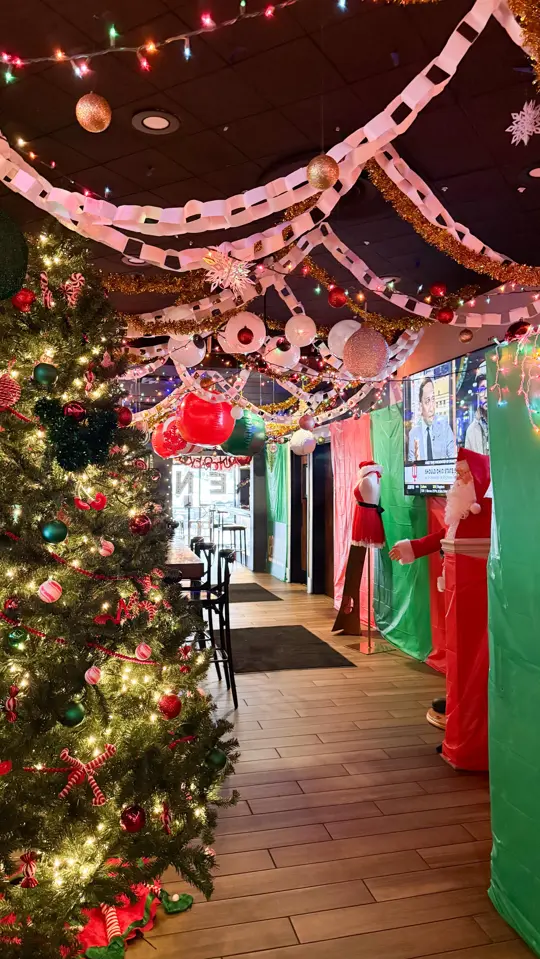 Three Roses Tavern in Marietta showing cocktail, festive atmosphere, elf pop-up event, video by Visit Marietta, GA on Facebook