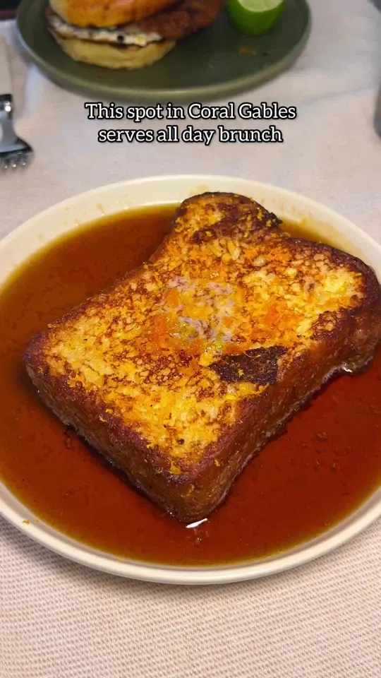 Tina in the Gables in Coral Gables showing review, visit, cafe creme, sunny side duck, steak and eggs, soft-shell crab sandwich, tina's french toast, video by iviethefoodie on TikTok