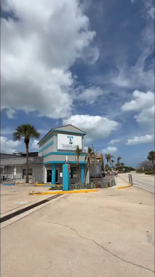 Twisted Tides Rooftop Beach Bar & Restaurant in Cocoa Beach showing cocktail, ocean breeze atmosphere, rooftop vibes, food, video by Cuckoo For Cocoa Beach on Facebook