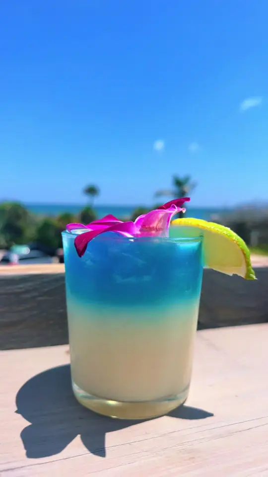 Twisted Tides Rooftop Beach Bar & Restaurant in Cocoa Beach showing cocktail, coconut sky margarita, rooftop views, video by twistedtides321 on TikTok