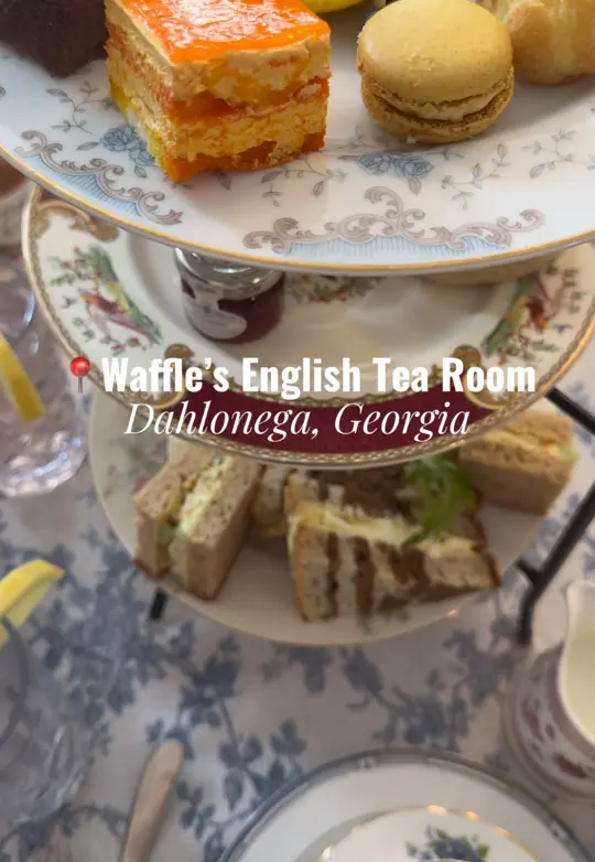 Waffle's English Tea Room in Dahlonega showing visit, afternoon tea service, tea sandwiches, scones with clotted cream and jam, pastries like creme puffs, themed tea varieties, video by katiegadventures on TikTok